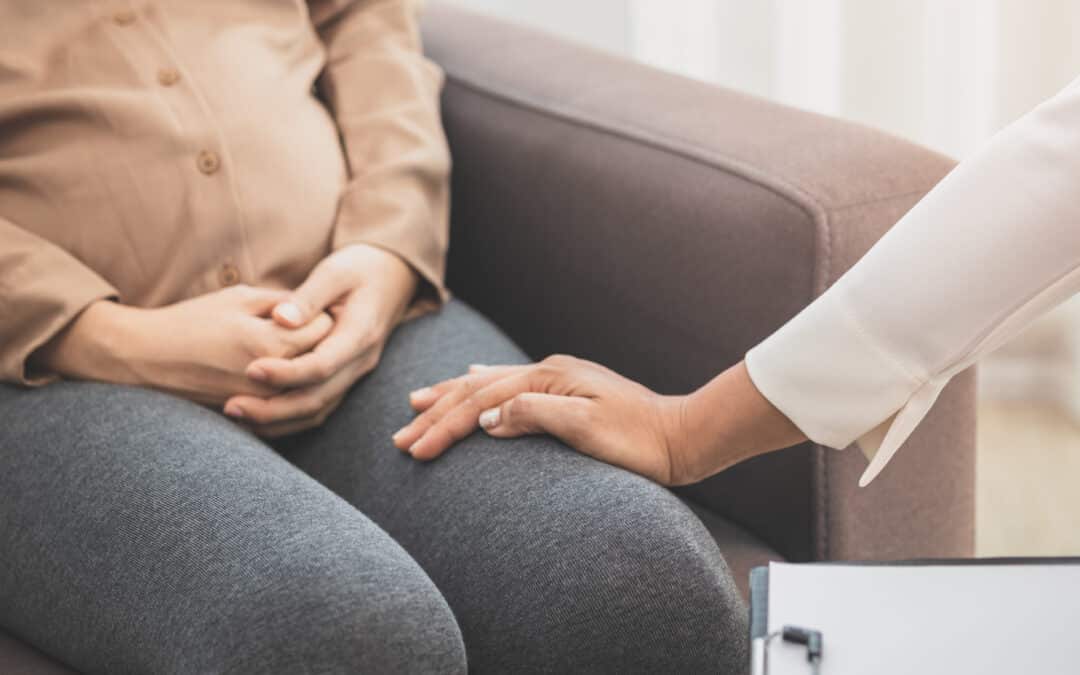 pregnant woman discussing her mental health with a professional