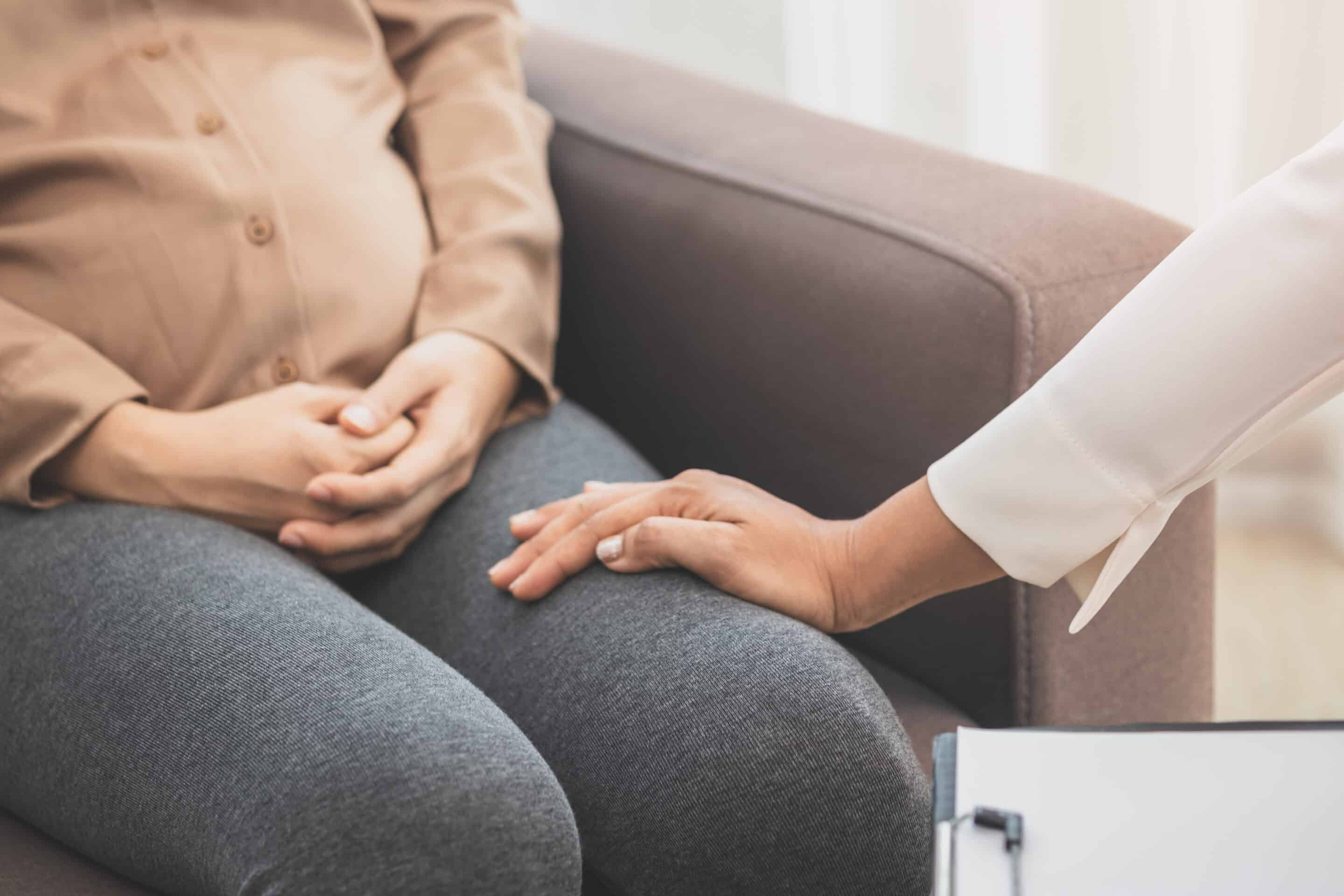pregnant woman discussing her mental health with a professional